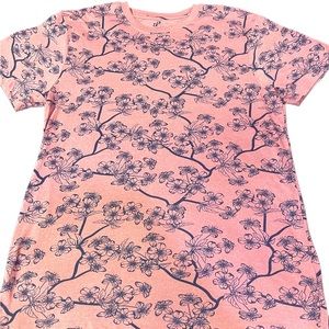 Pink tee shirt with blue floral print.
